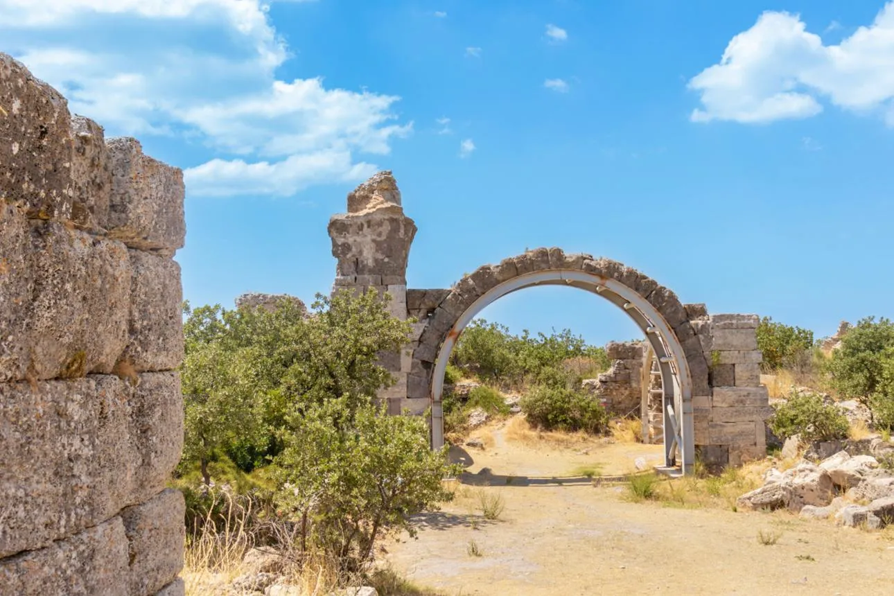A ruined stone arch among bushes at Alexandria Troas