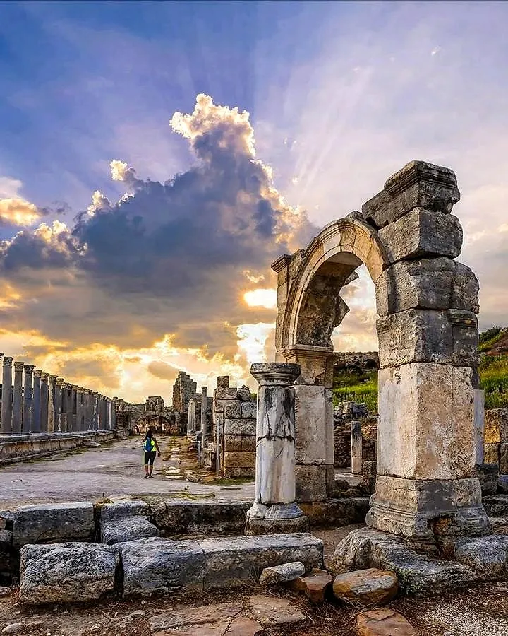 A Roman gate and colonnaded street at sunset