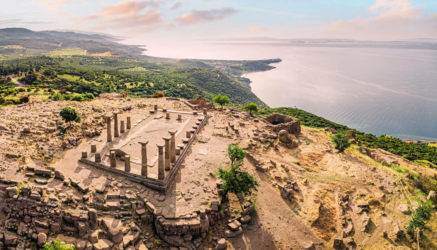 Aerial view of the Temple of Athena ruins on the hilltop of Assos above the sea