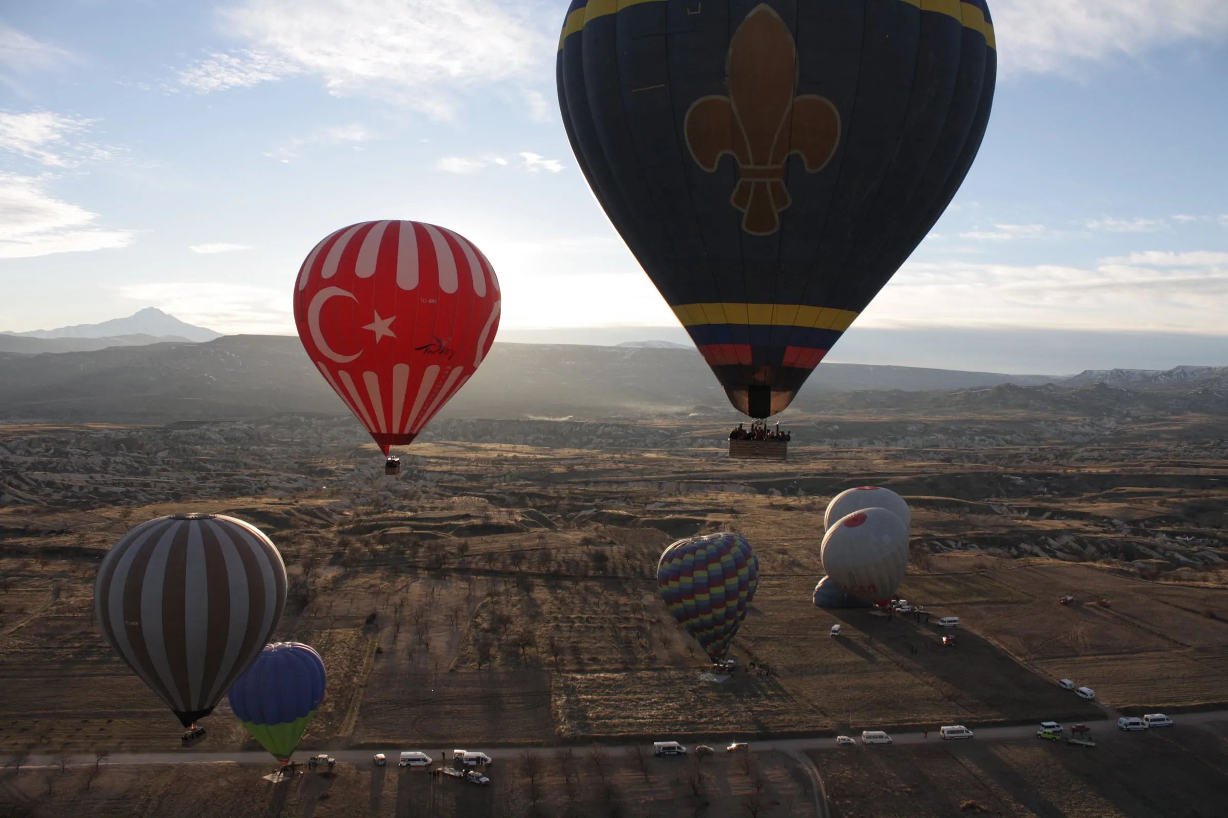 Hot air balloons rising over Cappadocia at dawn