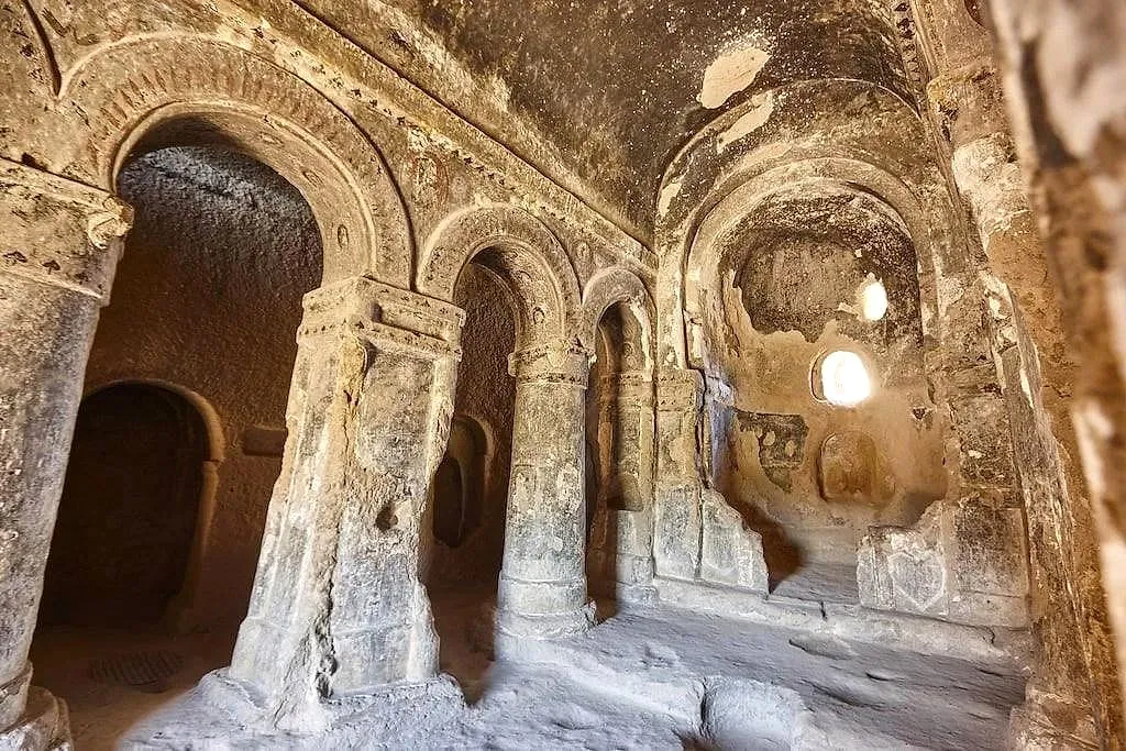 Carved arches and pillars inside a rock-cut church
