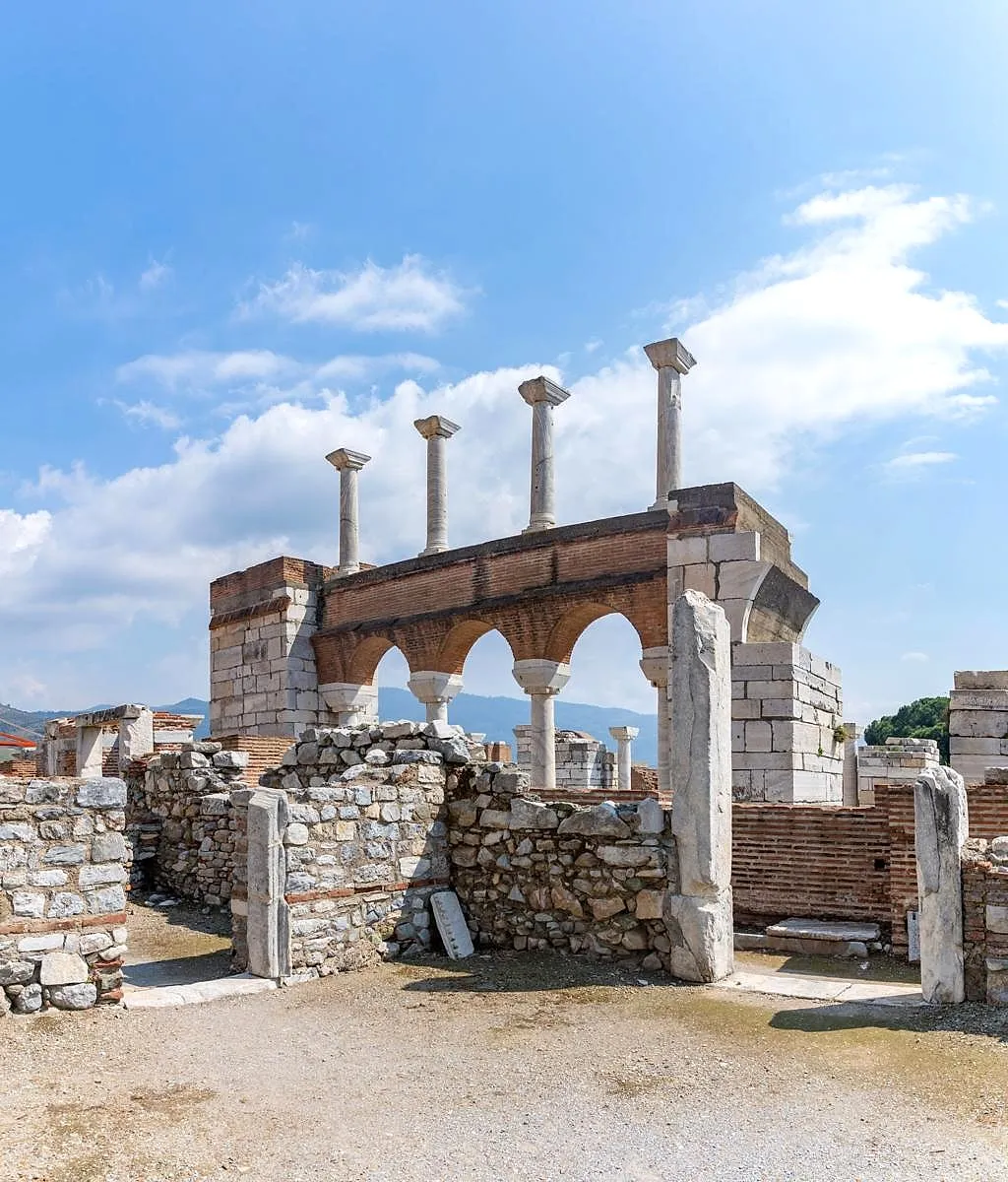 Ancient columns and arches against a blue sky in Ephesus