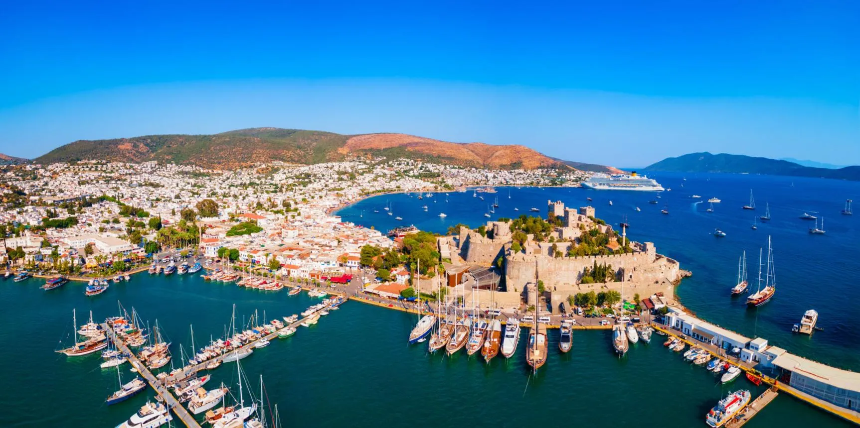 Bodrum Castle between its two harbours, with the white town and the hills behind