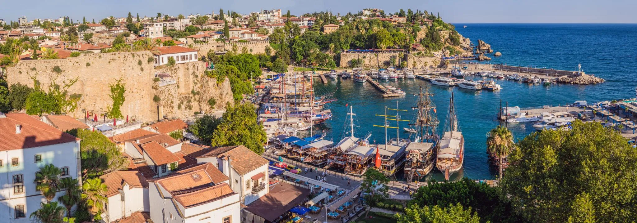 Antalya's old harbour and the red roofs of Kaleiçi above the turquoise sea